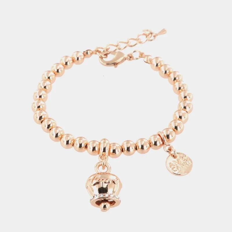 Metal bracelet with sphere links, featuring a bell with the word 'Capri' hanging, enhanced with crystals