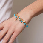 Metal Bracelet with Dangling Marine Symbols and Blue Stones