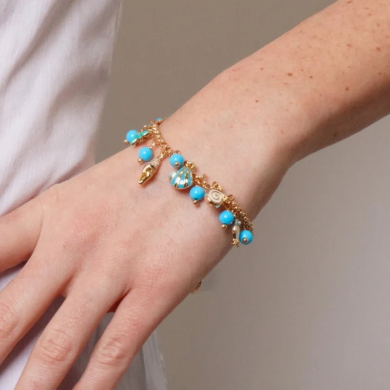 Metal Bracelet with Dangling Marine Symbols and Blue Stones
