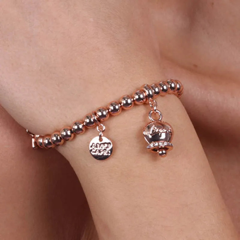 Metal bracelet with sphere links, featuring a bell with the word 'Capri' hanging, enhanced with crystals