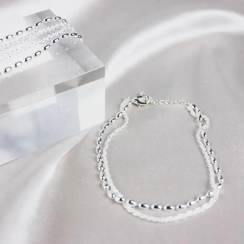 Elegant set of silver bracelets with zircon stones