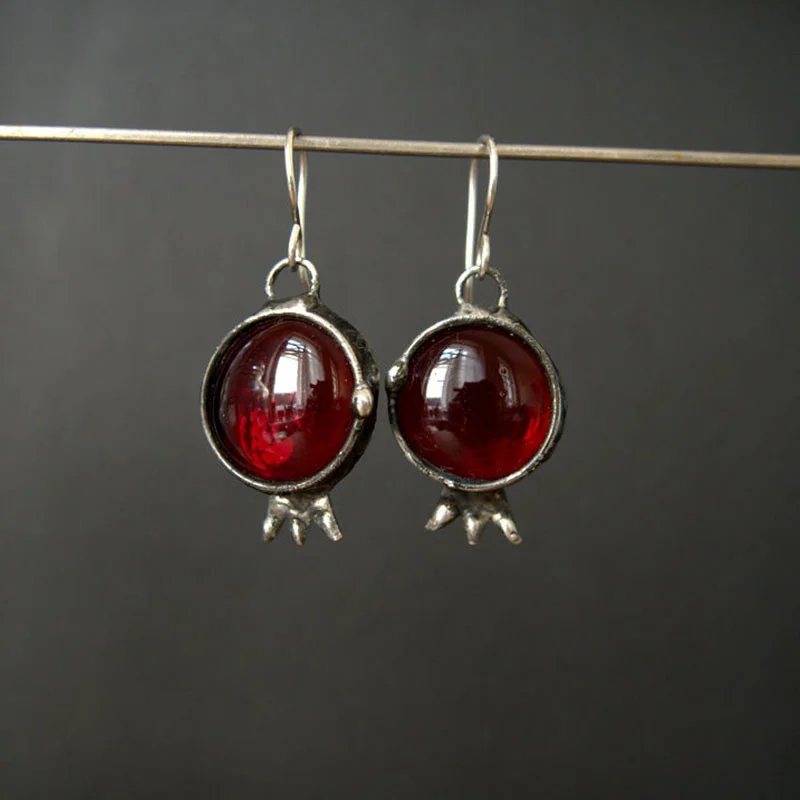 Vintage earrings with embedded red crystal